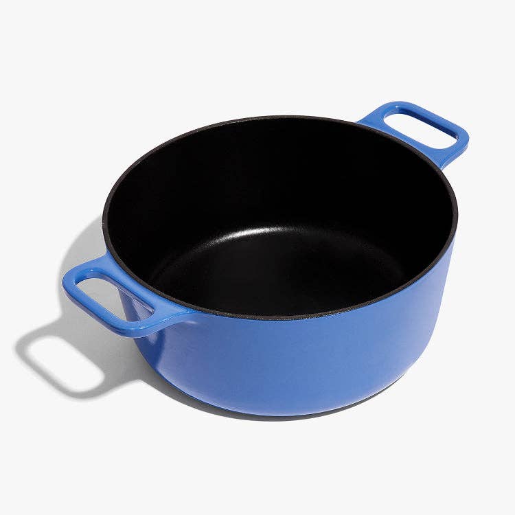 Blue enameled cast iron Dutch oven on a white background