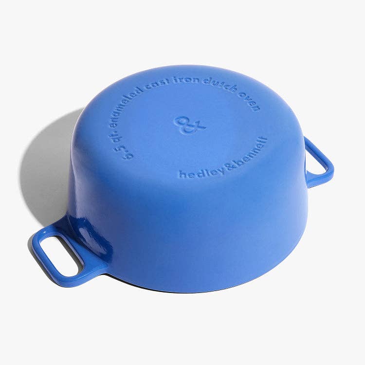 Blue cast iron Dutch oven with 'hedley & Bennett' branding on a white background