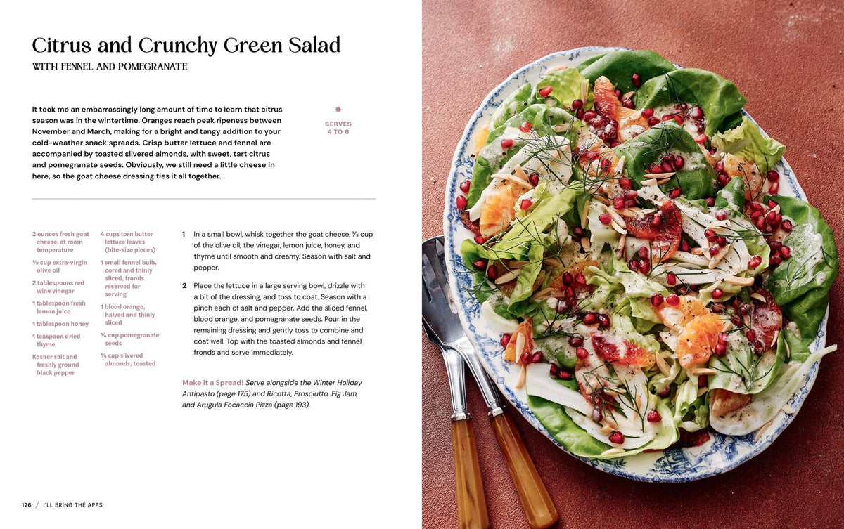 Salad with fennel and pomegranate on a plate with utensils, text on the left