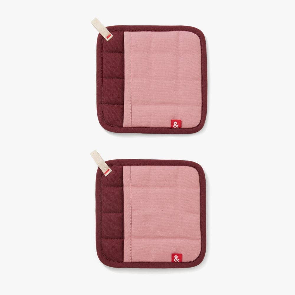 Two maroon and pink pot holders with a brand logo on a white background