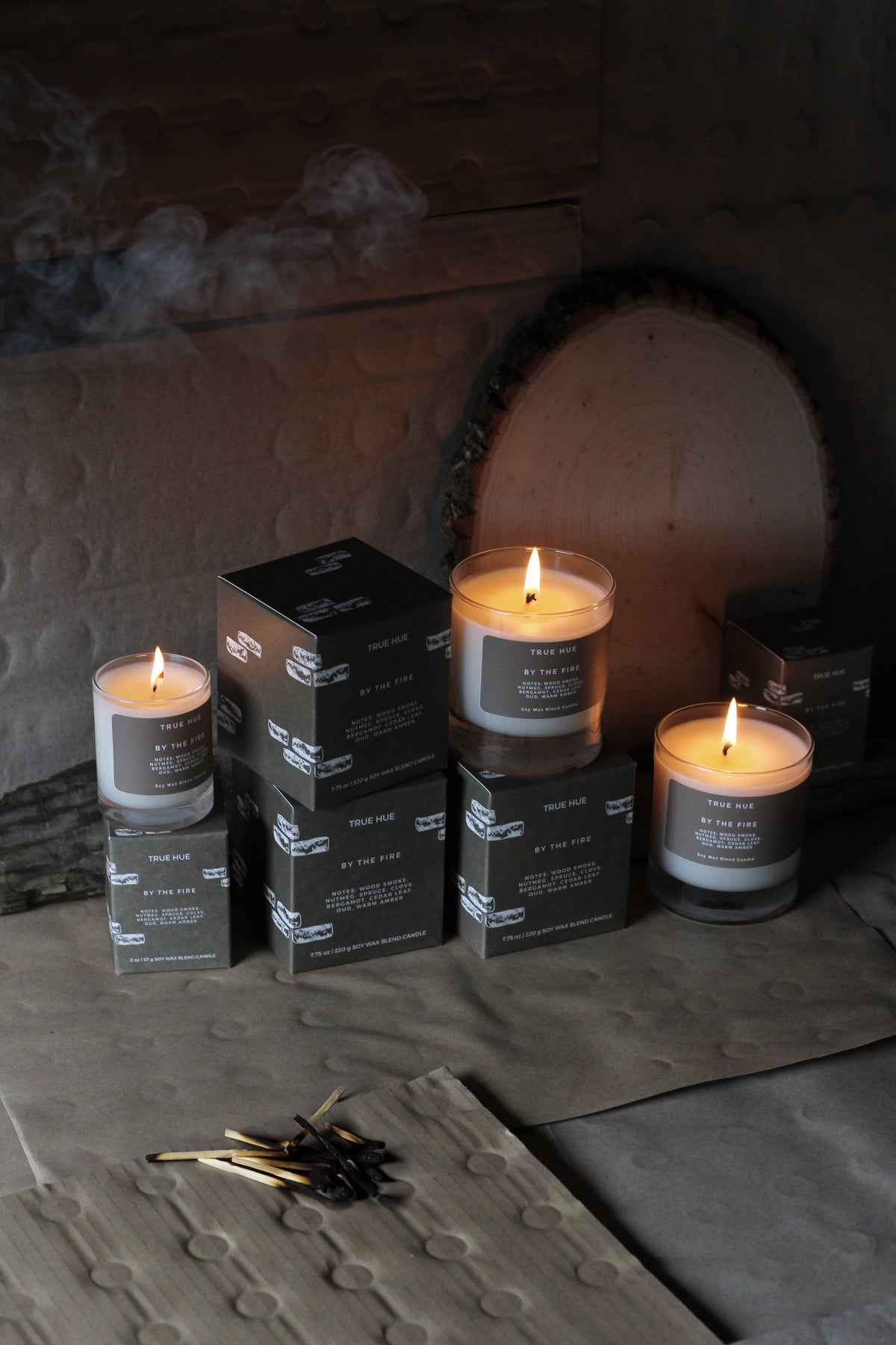 Candles and boxes on a stone surface with a rustic background
