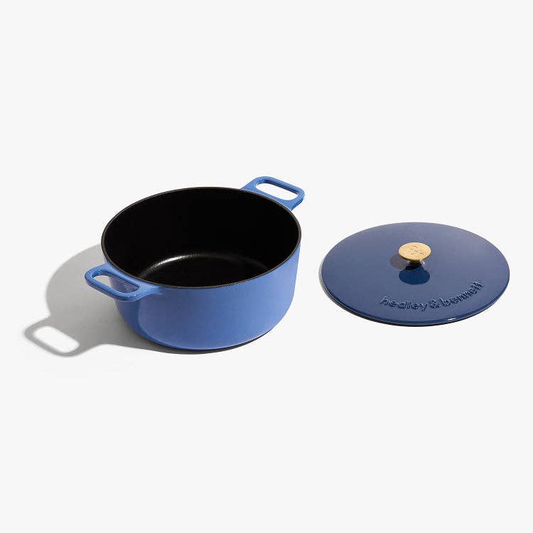 Blue enameled cast iron pot with lid on a white background