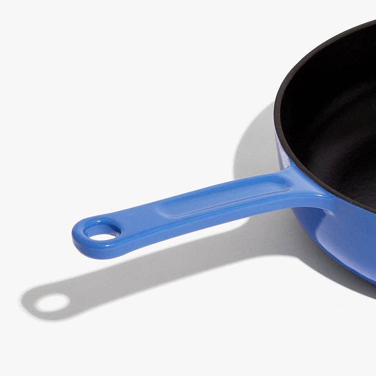 Blue-handled frying pan on a white background