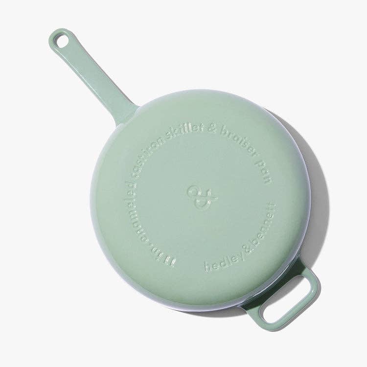 Light green ceramic cookware set with lid on a white background