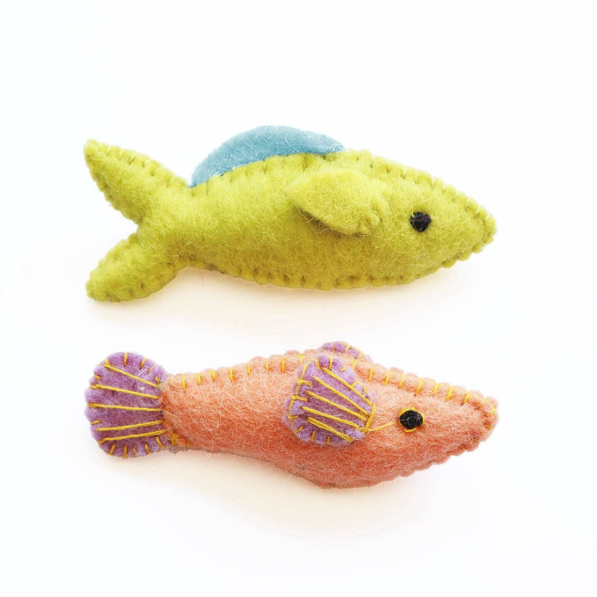 Two felt fish toys, one green and one pink with purple accents, on a white background.