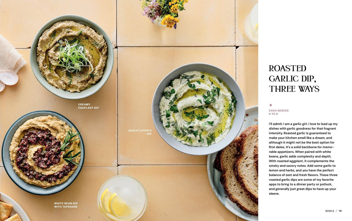 Three bowls of roasted garlic dip on a wooden table with text on the side.