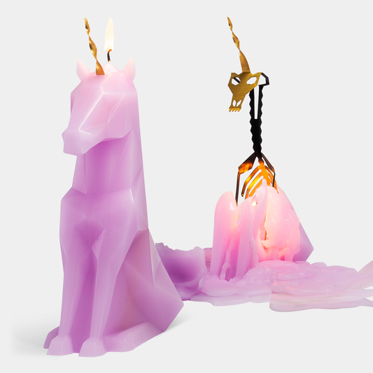 Candle with a decorative holder shaped like a cat on a white background