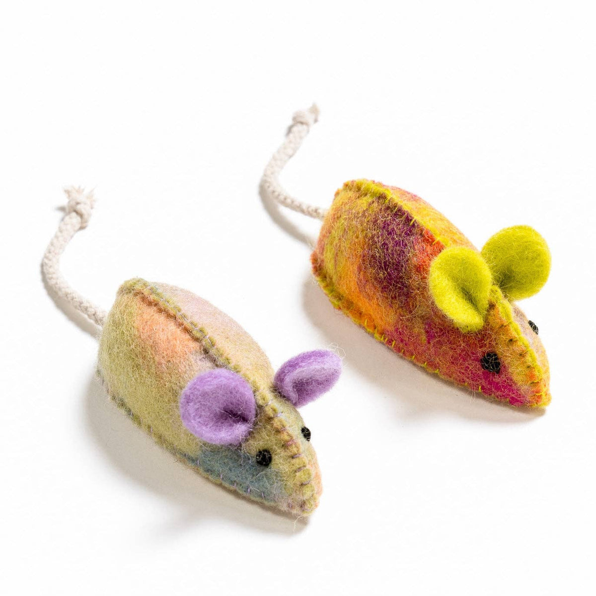 Two colorful felted mouse toys on a white background