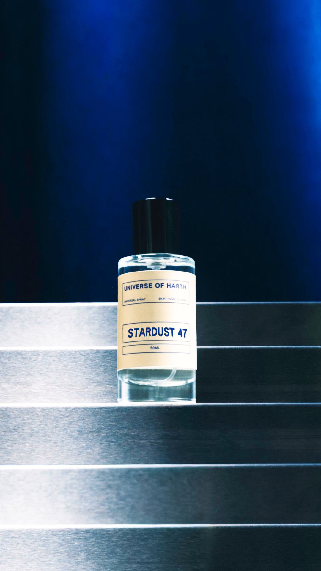 Bottle of 'Stardust 47' on a metallic surface with a dark blue background