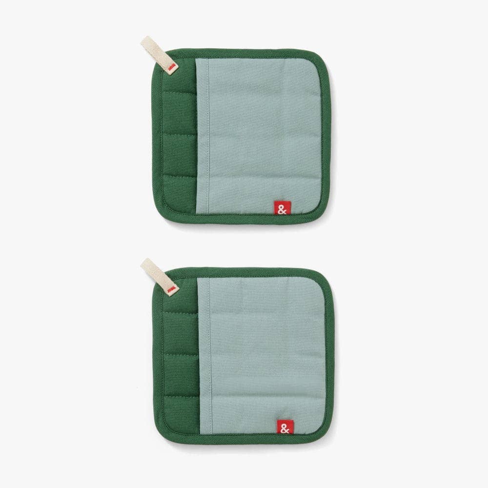 Two green pot holders with gray centers on a white background