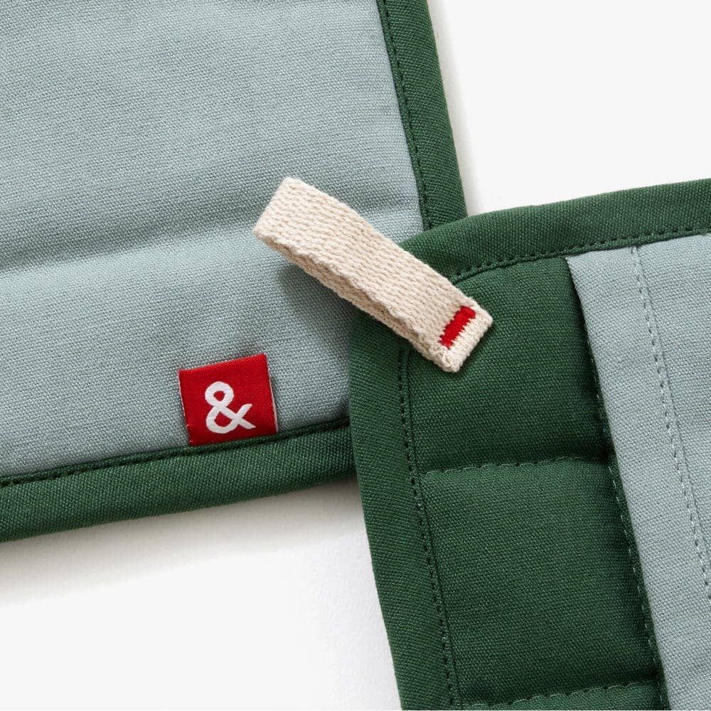 Two green and gray fabric pouches with a red and white logo tag on a white background