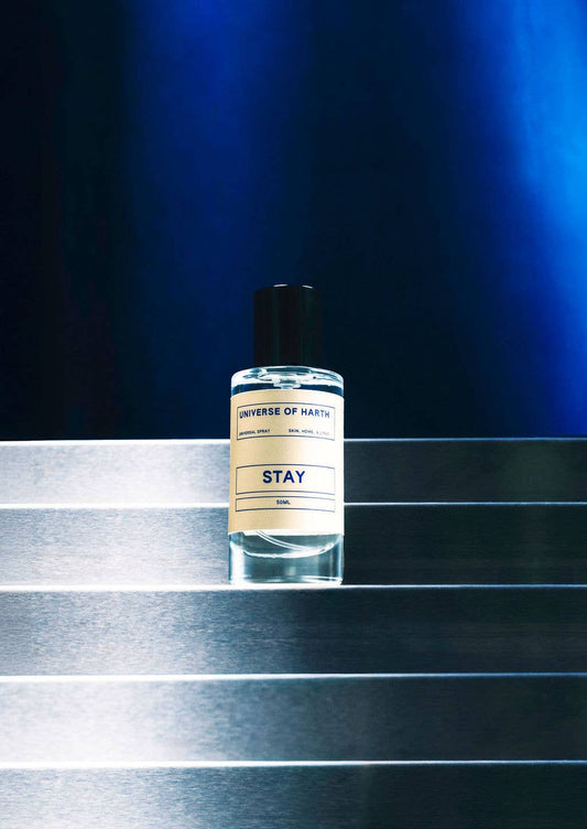 Bottle of 'Converse of Nature' 'Stay' on a reflective surface with a dark blue background