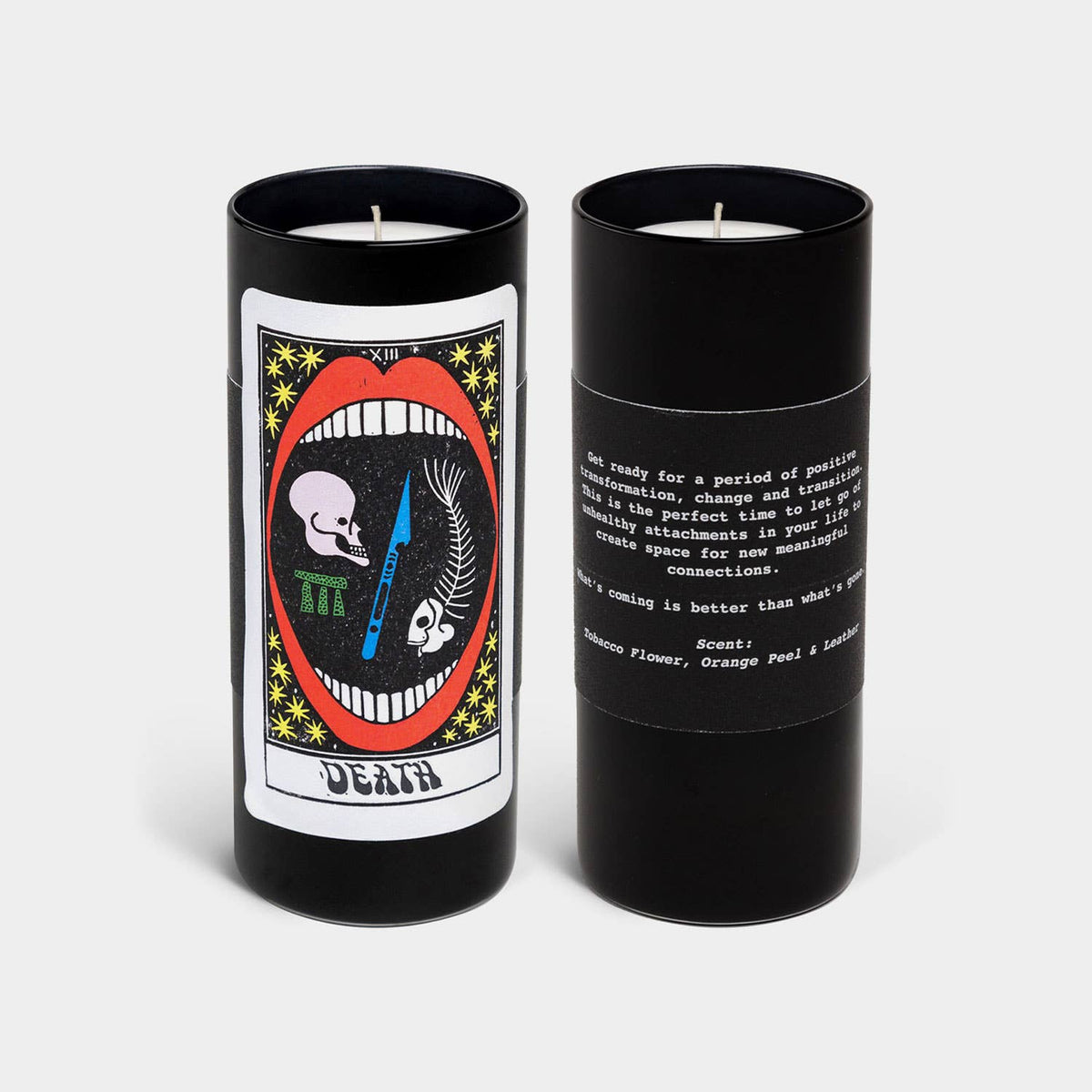 Front and back of a black candle with artistic labels on a white background