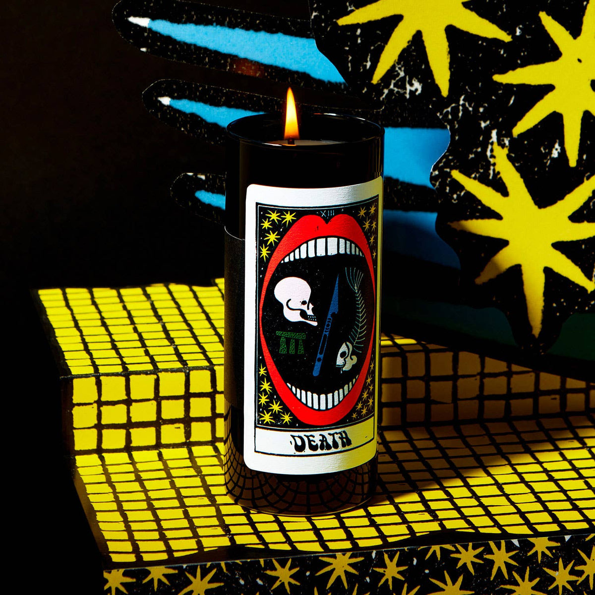 Candle with a graphic design on a colorful, abstract background