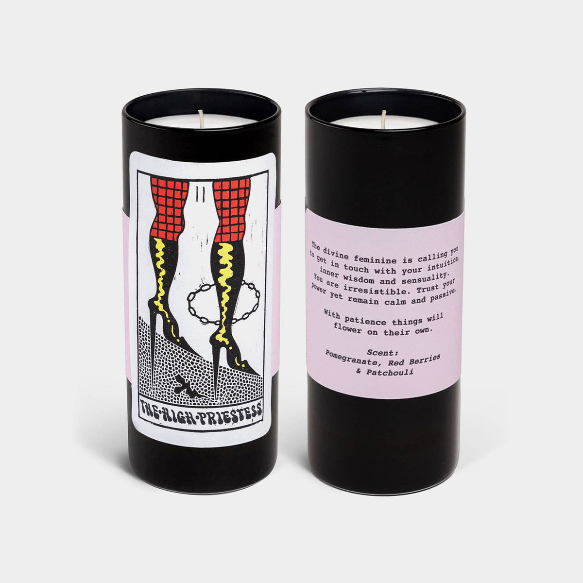 Two candles with black cylindrical containers and colorful labels on a white background
