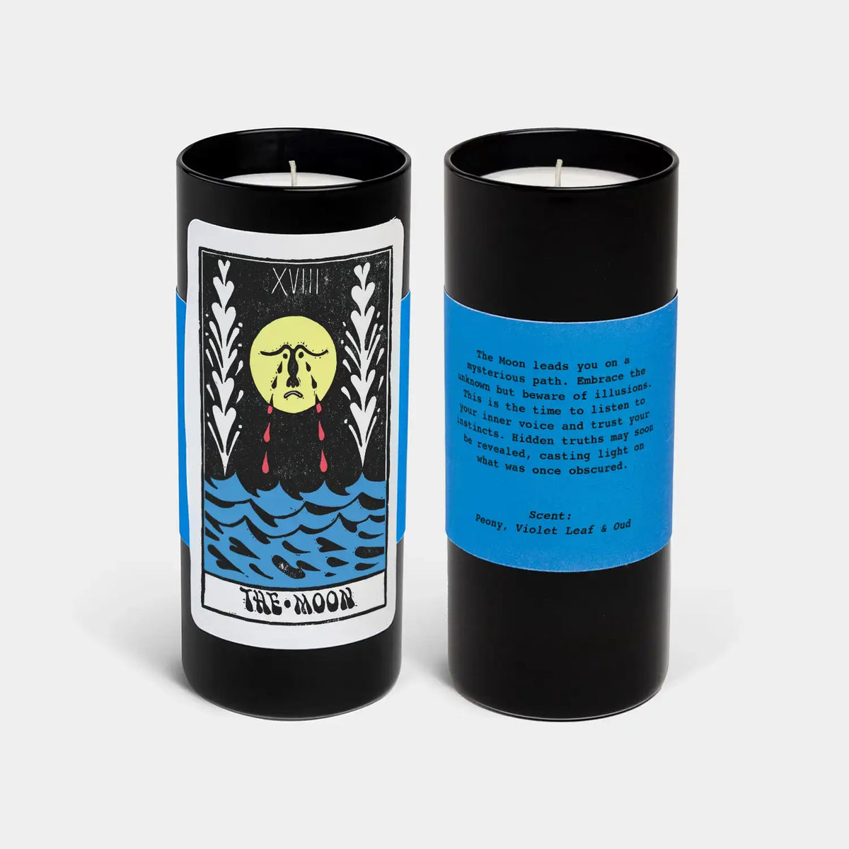 Two black candles with blue labels featuring tarot card designs on a white background