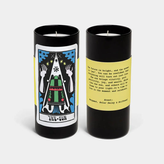Two candles with tarot card design and text on a white background