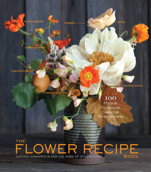 Book cover for 'The Flower Recipe Book' featuring a beautifully arranged floral arrangement in a rustic vase against a dark wood background, with handwritten-style labels pointing to flower parts and the title in large orange text at the bottom.