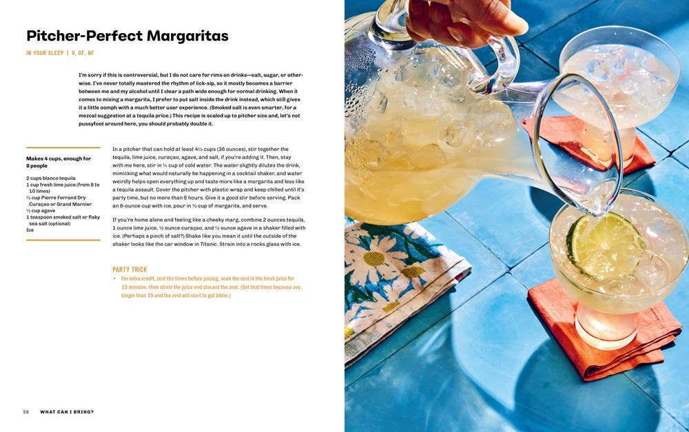 Person pouring a margarita into a glass on a blue tiled surface.