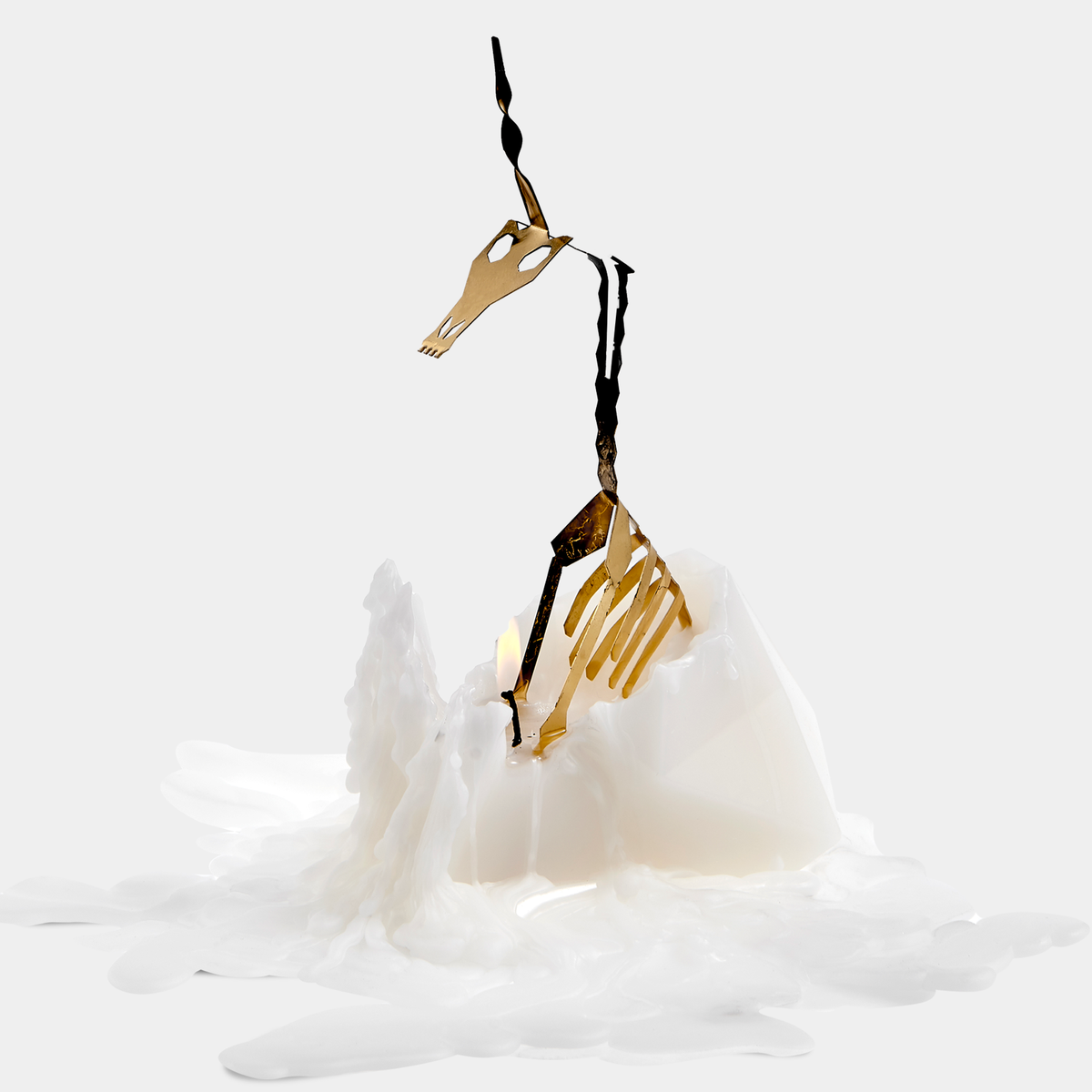 Decorative swan ornament with gold and black details on a white background