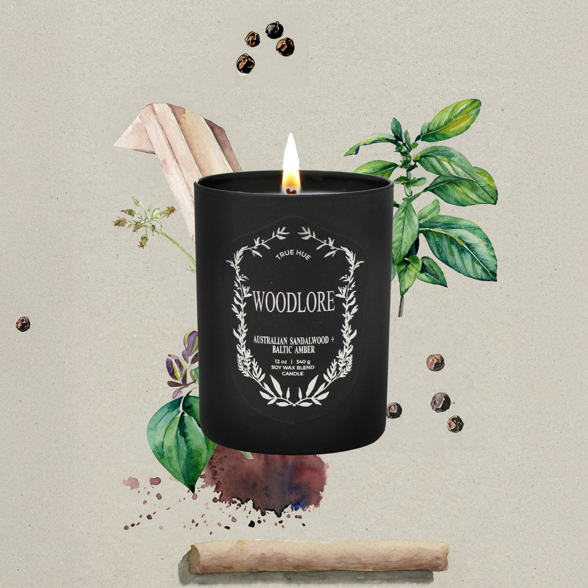Black candle labeled 'Woodlore' with decorative elements on a textured background